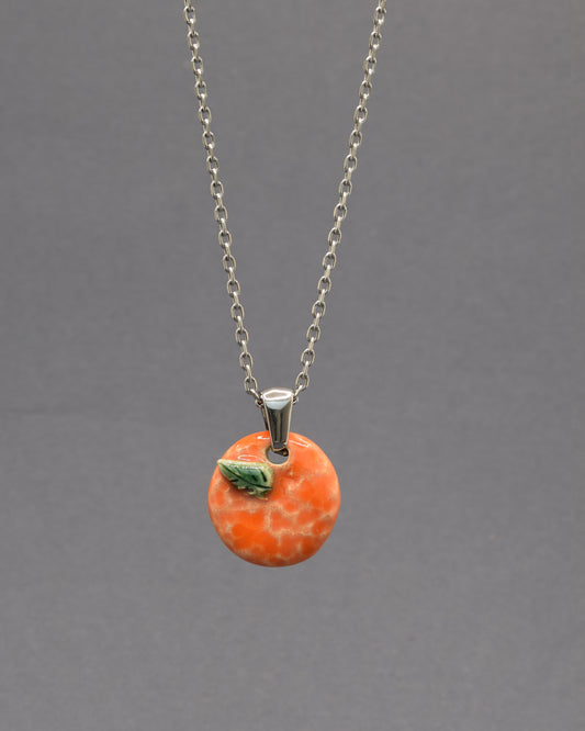 Colar com laranja e folha em cerâmica pintada à mão. Um apontamento de cor inspirado nos pomares portugueses, perfeito para dar vida a qualquer look.