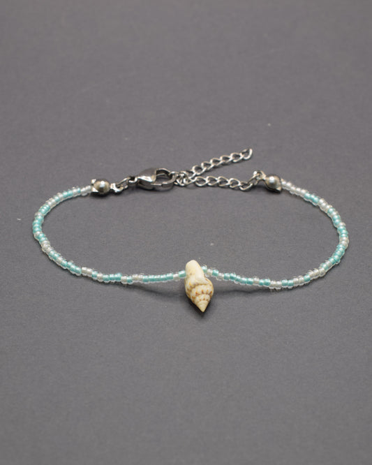 Pulseira Búzio de missangas em mix turquesa semitransparente, com brilho fresco e detalhes naturais que evocam mar e tranquilidade.