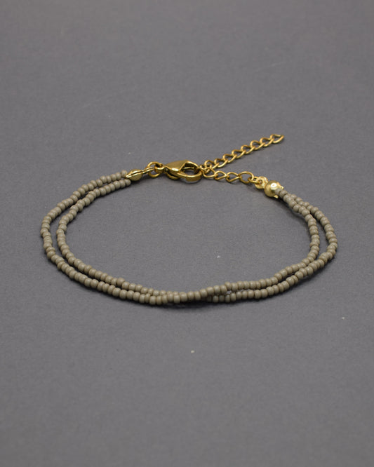 Pulseira dupla com missangas cinzentas. Design artesanal e elegante para um toque sofisticado no seu look.